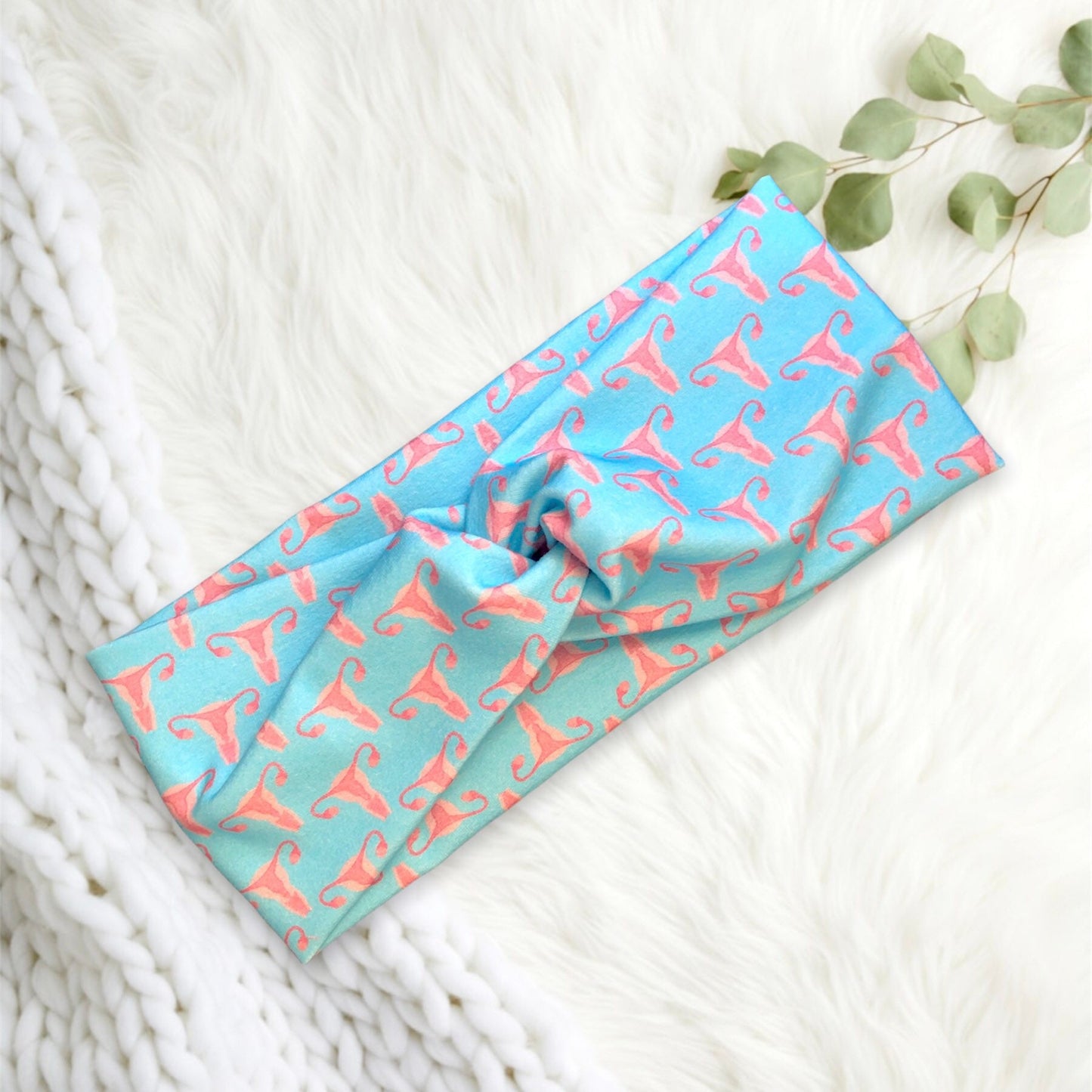 A stylish headband with a uterus surrounding on a light blue background.