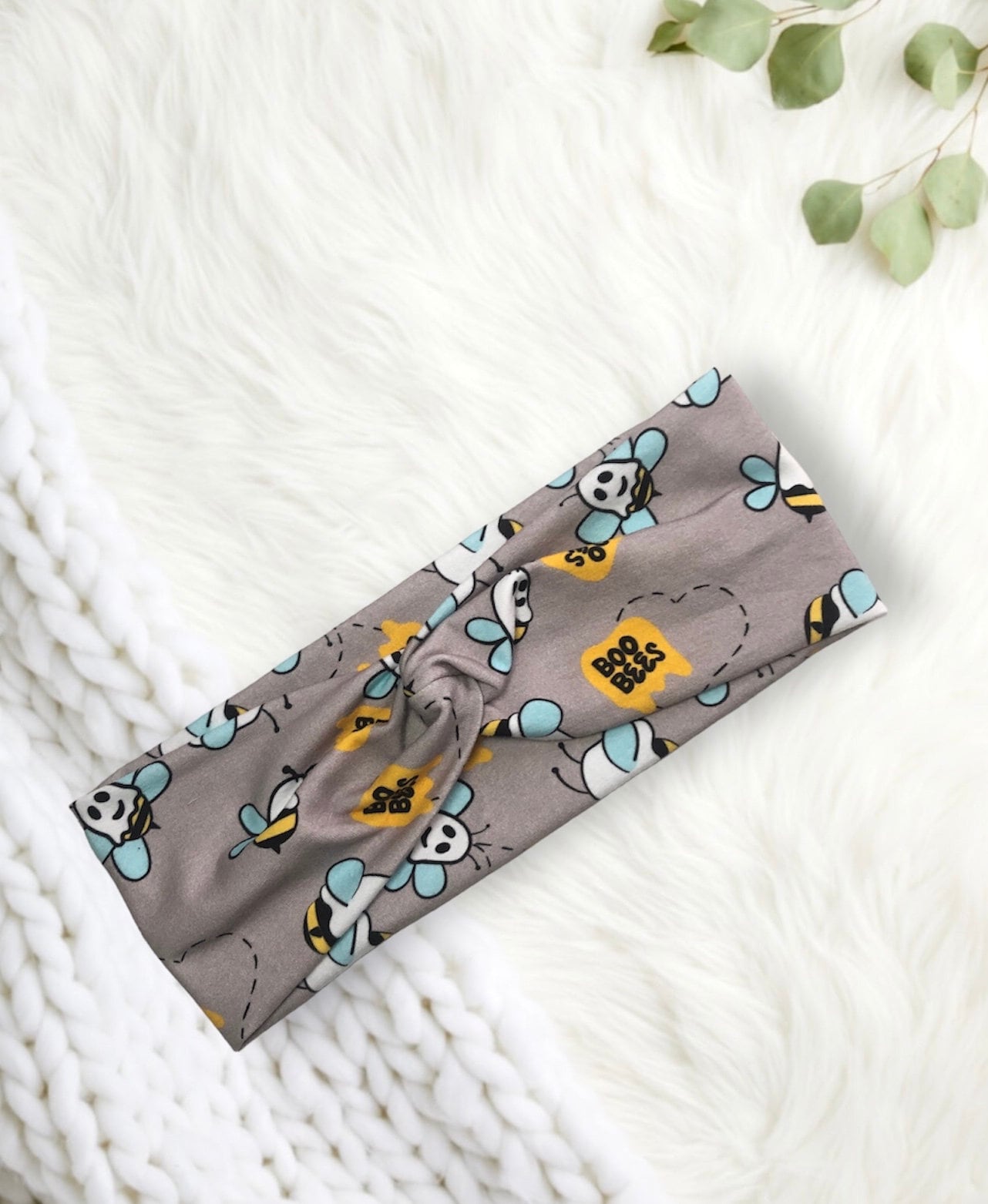 A cute grey headband featuring cartoon bees with "Boo Bees" text and blue wings.